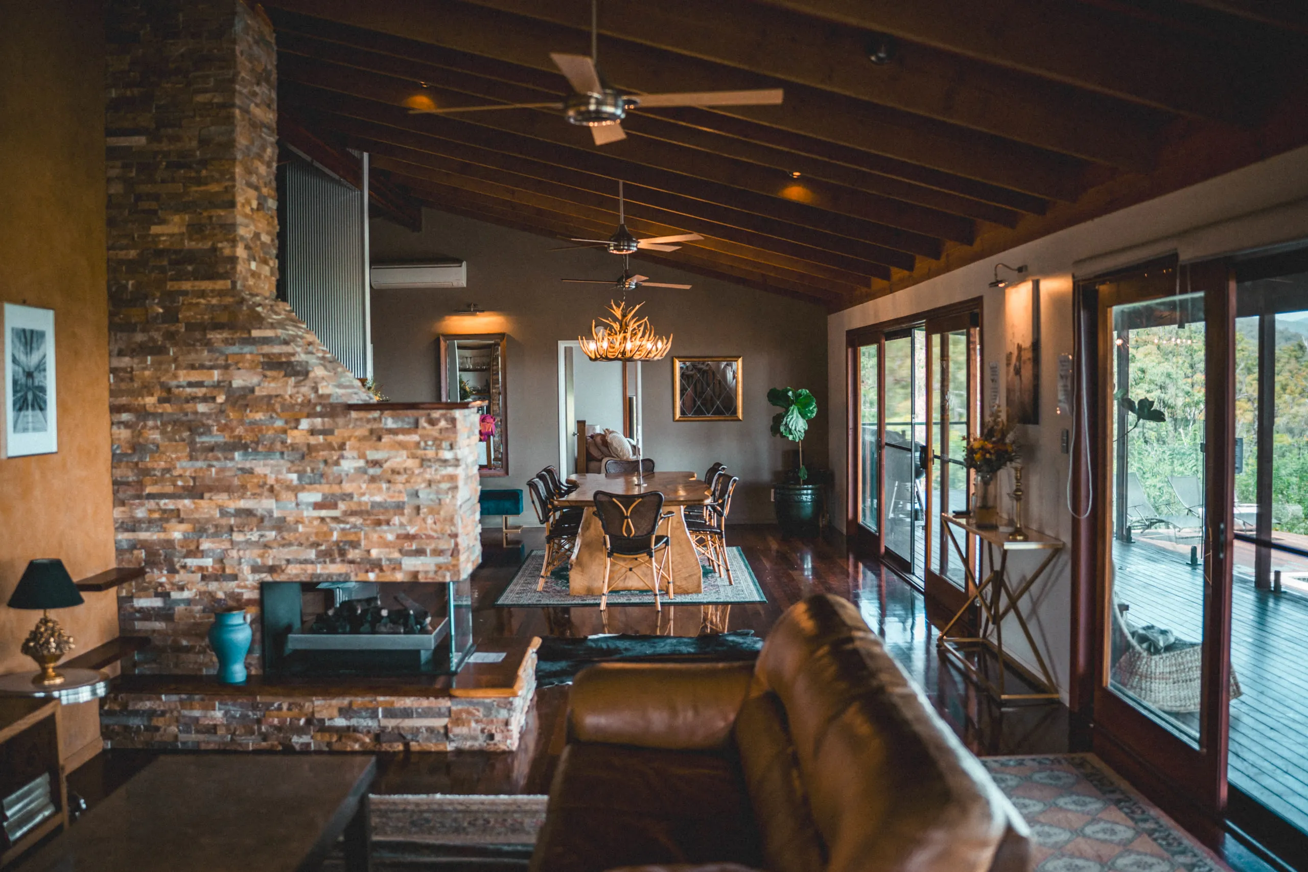 Tall, moody interior — raked timber ceilings and polished hardwood