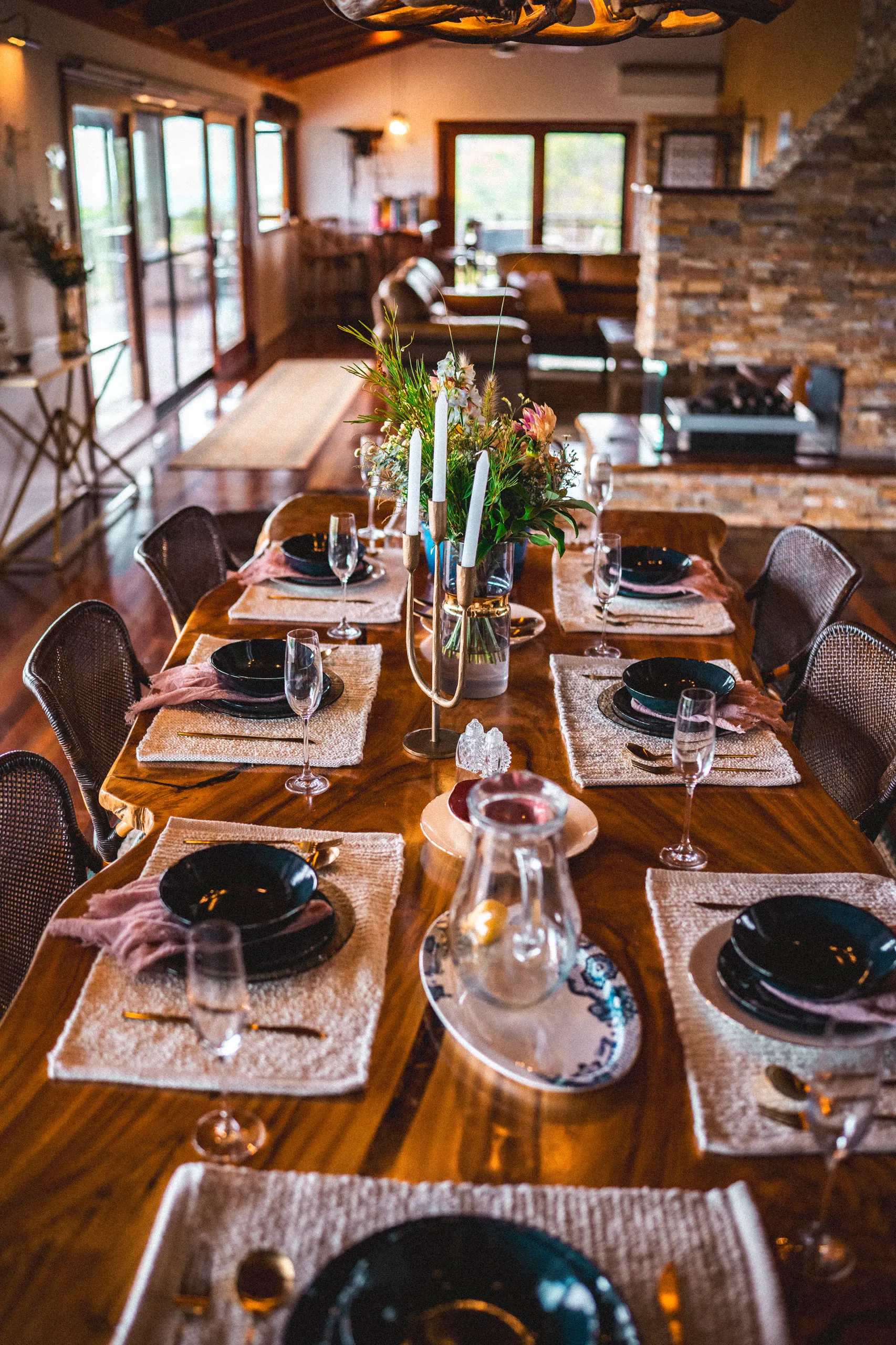 A long table set for dinner beside the fire